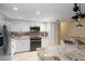 Modern kitchen featuring stainless steel appliances and granite countertops at 9341 Blind Pass Rd, St Pete Beach, FL 33706