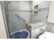 Large walk-in shower with glass enclosure, built-in seat, and blue tile floor at 9341 Blind Pass Rd, St Pete Beach, FL 33706