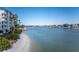 Stunning view of waterfront property with sandy beach and calm waters at 9341 Blind Pass Rd, St Pete Beach, FL 33706