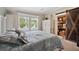 Guest bedroom with white bed frame, barn door, and carpet flooring at 2715 9Th N Ave, St Petersburg, FL 33713