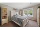 Guest bedroom with white bed frame, built-in shelving, and carpet flooring at 2715 9Th N Ave, St Petersburg, FL 33713