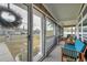 Screened porch with blue seating and view of the street at 2715 9Th N Ave, St Petersburg, FL 33713