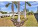 Landscaped yard with palm trees and a white fence at 2715 9Th N Ave, St Petersburg, FL 33713