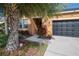 House exterior showcasing walkway, landscaping, and a black garage door at 11810 Winterset Cove Dr, Riverview, FL 33579