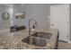 Kitchen island with granite countertop and double stainless steel sink at 11810 Winterset Cove Dr, Riverview, FL 33579