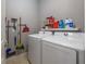 Laundry room with washer, dryer, and shelving for cleaning supplies at 11810 Winterset Cove Dr, Riverview, FL 33579