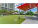 Modern dog park with artificial turf and covered seating at 1208 E Kennedy Blvd # 410, Tampa, FL 33602