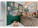 Stylish home bar with green walls and unique artwork at 1208 E Kennedy Blvd # 410, Tampa, FL 33602