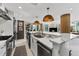 Modern kitchen with island, stainless steel appliances, and white cabinetry at 1208 E Kennedy Blvd # 410, Tampa, FL 33602