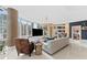 Spacious living room with floor to ceiling windows, stylish furniture, and a large TV at 1208 E Kennedy Blvd # 410, Tampa, FL 33602