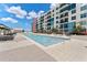 Community pool with ample lounge space and building view at 1208 E Kennedy Blvd # 410, Tampa, FL 33602