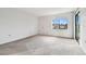 Spacious bedroom with carpet and sliding glass doors at 130 Lakeview Way # 130, Oldsmar, FL 34677