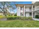 Condo building exterior showcasing entrance and landscaping at 130 Lakeview Way # 130, Oldsmar, FL 34677