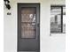 Condo entrance with a dark brown door at 130 Lakeview Way # 130, Oldsmar, FL 34677