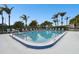 Inviting community pool surrounded by palm trees at 130 Lakeview Way # 130, Oldsmar, FL 34677