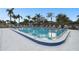 Relaxing community pool with ample lounge chairs at 130 Lakeview Way # 130, Oldsmar, FL 34677