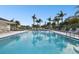 Community pool with lounge chairs and a pool house at 130 Lakeview Way # 130, Oldsmar, FL 34677