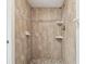 Shower stall with beige tiles and hexagon accents at 130 Lakeview Way # 130, Oldsmar, FL 34677