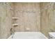 Beige tiled shower with built in shelving at 130 Lakeview Way # 130, Oldsmar, FL 34677