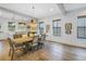 Bright dining room with farmhouse table and chandelier, adjacent to kitchen at 1334 17Th N Ter, St Petersburg, FL 33704