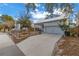 Modern house exterior with a metal roof, two-car garage, and fenced yard at 1334 17Th N Ter, St Petersburg, FL 33704