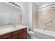 Standard bathroom offers a vanity with a wood cabinet and a shower-tub combo with grab bars at 1354 Emerald Dunes Dr, Sun City Center, FL 33573