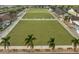 Two bocce ball courts with benches and palm trees at 1354 Emerald Dunes Dr, Sun City Center, FL 33573