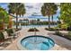 Resort-style community pool and hot tub surrounded by pavers, palm trees and lounge seating at 1354 Emerald Dunes Dr, Sun City Center, FL 33573