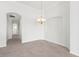 Spacious dining room with chandelier and neutral decor at 1354 Emerald Dunes Dr, Sun City Center, FL 33573