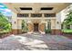 Ornate columns and a grand wooden door create an impressive entryway at 1354 Emerald Dunes Dr, Sun City Center, FL 33573
