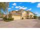 Two-story home with attached garage and view of the water at 1354 Emerald Dunes Dr, Sun City Center, FL 33573