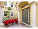 Gray front door entrance with red poinsettias at 1354 Emerald Dunes Dr, Sun City Center, FL 33573