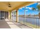 Spacious screened-in lanai with fan overlooks a serene lake, offering relaxing outdoor living at 1354 Emerald Dunes Dr, Sun City Center, FL 33573