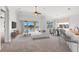 Open-concept living room features lake views, modern furniture, and a seamless transition to the dining area at 1354 Emerald Dunes Dr, Sun City Center, FL 33573