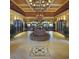 Spacious lobby with a circular seating area and elegant chandelier at 1354 Emerald Dunes Dr, Sun City Center, FL 33573