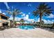 Resort-style pool with ample lounge chairs and palm trees at 1354 Emerald Dunes Dr, Sun City Center, FL 33573