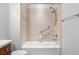 Bathroom shower-tub combo features safety grab bars and tile surround; a safe and practical design at 1354 Emerald Dunes Dr, Sun City Center, FL 33573
