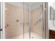 Walk-in shower with grab bars and neutral tile at 1354 Emerald Dunes Dr, Sun City Center, FL 33573