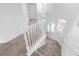 Bright stairway features neutral carpet on stairs and landing, white trim, and natural light from three windows at 1354 Emerald Dunes Dr, Sun City Center, FL 33573