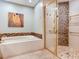 Bathroom with walk-in shower, soaking tub, and mosaic tile at 1503 Limona Rd, Brandon, FL 33510