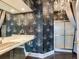 Bathroom boasts a double vanity, chandelier wallpaper, and glass shower at 1503 Limona Rd, Brandon, FL 33510