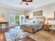 Primary bedroom with king bed, access to backyard, and wood floors at 1503 Limona Rd, Brandon, FL 33510
