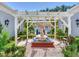 Inviting courtyard featuring a stunning statue and pergola at 1503 Limona Rd, Brandon, FL 33510