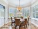 Bright dining room with a round table and four chairs, surrounded by windows with white shutters at 1503 Limona Rd, Brandon, FL 33510