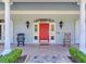 Inviting front entrance with red door and rocking chairs at 1503 Limona Rd, Brandon, FL 33510
