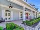 Elegant front porch with columns, swing, and landscaping at 1503 Limona Rd, Brandon, FL 33510