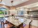 Island kitchen features granite countertops, stainless steel appliances, and an eat-in area at 1503 Limona Rd, Brandon, FL 33510