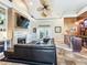 Open living room with sectional sofa, fireplace, and built-in wet bar at 1503 Limona Rd, Brandon, FL 33510