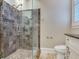 Large walk-in shower with marble tile and pebble floor at 1503 Limona Rd, Brandon, FL 33510