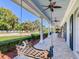 Long side porch with a swing and view of the yard at 1503 Limona Rd, Brandon, FL 33510